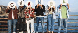 People holding up letters that spell "Change."