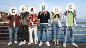 People holding up letters that spell "Change."