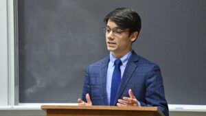 A person speaking at a podium.