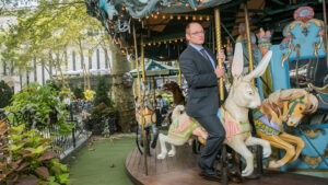 A person riding a carousel.