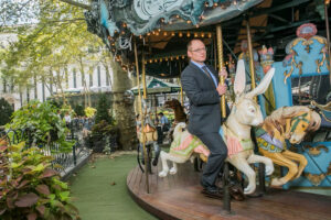 A person riding a carousel.